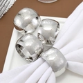 Set of 4 silver hammered metal napkin rings with embossed texture on white cloth - Hammered Texture / Silver