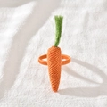 Handmade woven carrot napkin ring with orange and green crochet on white linen - Carrot Rope Woven