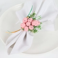 Detail of pink spotted Easter egg napkin ring with faux greenery and ribbons - Pink