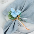Close-up of Easter egg napkin ring with speckled blue egg and greenery on linen - Blue