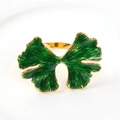 Macro shot of golden ginkgo leaf napkin ring with green enamel finish and detailed veins - Green