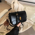 Minimalist black PU leather crossbody bag with gold buckle and brown pom-pom charm - With Pendant / Black PU Leather