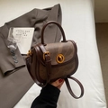 Vintage brown shoulder bag with gold twist lock and adjustable strap on neutral background - Coffee