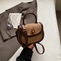 Retro brown leather saddle bag with golden circular twist lock and top handle - Brown