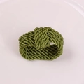 Macro detail of dark blue braided cord napkin ring with textured spiral rope weave - Green