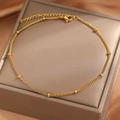 Classic gold bead chain anklet with lobster clasp on elegant jewelry display - Gold