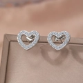 Sweet silver heart-shaped stud earrings with pave crystals on a jewelry display box - Silver Hollow Heart Style (F1398)