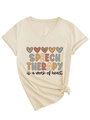 Detail of V-neck cotton T-shirt featuring Speech Therapy heart print and knot hem design - S / Sand