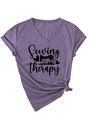 Detail view of purple V-neck t-shirt with Sewing is my therapy print and knotted hem detail - Purple (Black Text)