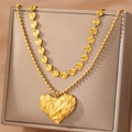 Gold plated layered necklace with sun texture discs and a wrinkled heart pendant on box - Gold Crumpled Heart Style (F959)