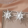 Polierte silberne Sonnenblumen-Ohrringe auf einer braunen Leder-Schmuckschatulle - Silberner Sonnenstrahl-Stil (C9730)