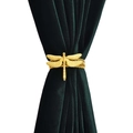 Detail of a golden dragonfly curtain tieback featuring a textured alloy wing design - Gold Dragonfly Style