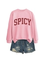Detail of pink SPICY sweatshirt with distressed denim shorts as a casual women outfit - Pink