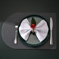 Close-up of a woven D-shaped placemat styled with a festive napkin ring and cutlery - Red Berry Woven Style