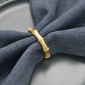 Elegant gold bamboo joint napkin ring on dark blue linen napkin for dining table decor - Matte Gold