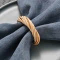 Natural rattan napkin ring handmade with wood vines on a blue linen cloth table setting - Rattan Woven Napkin Ring
