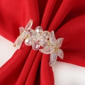 Macro view of crystal flower napkin ring with intricate gold wire and leaf detail - Crystal Flower Style