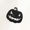Detail of black metal Jack-o'-lantern napkin ring with a cutout face on white fabric - Pumpkin Style
