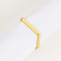 Close-up of a gold rectangular napkin ring with a polished mirror finish on a white napkin - Square Napkin Ring