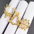 Detailed view of gold reindeer, Christmas tree, and snowflake napkin rings on white linens - 3 Pcs/Set (Hollow Christmas Tree/Reindeer/Snowflake/Gold)