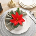 Detailed view of handmade red poinsettia napkin ring with pine cones on elegant tableware - Red Poinsettia Napkin Ring