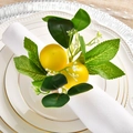 Close-up of handmade lemon napkin ring with realistic greenery and white flowers - Hand-Woven Lemon Style