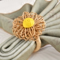 Macro detail of Bohemian handmade straw flower napkin ring with woven yellow core - Brown Handmade Straw Flower