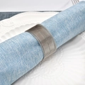 Silver woven metal mesh napkin ring on light blue linen napkin with white plate - Silver