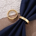 Modern minimalist gold metal napkin rings set on dark blue cloth for wedding decor - Gold Circle Metal Napkin Ring