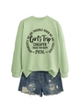 Flat lay of a mint green sweatshirt with Girl's Trip print and distressed denim shorts - Olive Green (Black Font)