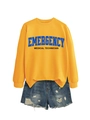 Detail of yellow Emergency Medical sweatshirt with ribbed cuffs and blue denim shorts - Yellow Sweatshirt (Black Text)