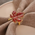 Elegant red maple leaf napkin ring with gold trim on a brown textured napkin - Red Enamel Maple Leaf (ZWZ-18-409)