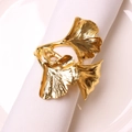 Golden ginkgo leaf napkin ring made of metal shown on a white napkin for table setting - Gold