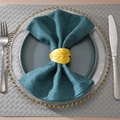 Golden leaf napkin ring detail with natural veins and elegant metal finish on a navy napkin - Gold