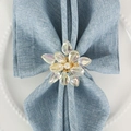 Iridescent crystal flower napkin ring with pearl center and gold alloy base on blue linen - Gold-Colored Rhinestone Woven Style (ZWZ-PNR-1112 Style A)