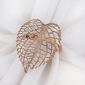 Hollow leaf napkin ring in rose gold finish on a white fabric napkin for table decor - Rose Gold