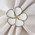 Detailed view of white five-petal flower napkin ring with elegant gold stamen and black edges - White Five-Petal Flower (Style 2)