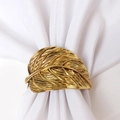 Golden double leaf metal napkin ring with detailed vein textures on white fabric background - Ancient Gold Two Leaves Style