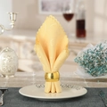 Golden wavy striped napkin ring with spiral texture on an elegant table setting - Gold