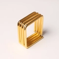 Detailed macro view of triple-layered golden square metal napkin ring with polished finish - Square Napkin Ring / Gold