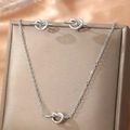 Elegant silver knot necklace and stud earring set displayed on a champagne jewelry box - Knot Design Set / Silver (F158)