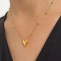 Minimalist gold heart pendant necklace with beaded chain on neck for women - Gold