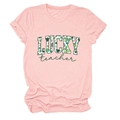 Close-up of Lucky Teacher lettering and green shamrock pattern on a pink cotton t-shirt - Pink