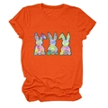 Close-up of orange t-shirt with three colorful tie-dye rabbit graphics and ribbed neck - Orange