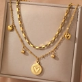 Double layer 18K gold chain necklace with sunburst heart pendant on jewelry display - Gold Double Layer Heart Pendant Style (F517)