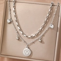Double-layered silver necklace with heart charms and polished disc on a jewelry box - Silver Double Layer Heart Pendant Style (F518)