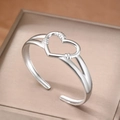Minimalist silver-toned open cuff bracelet featuring an intricate hollow heart design - Silver (F2744)