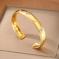 Brazalete abierto de acero inoxidable chapado en oro de 18k con grabados de estrellas - Estilo Dorado (F2971)