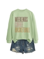 Flat lay of light green sweatshirt with color gradient print and ripped denim shorts - Olive Green