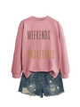 Flat lay of pink sweatshirt with 'WEEKENDS COFFEE' text and distressed denim shorts - Rose Gold